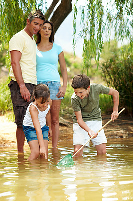 Buy stock photo Family, net and fishing in lake for vacation with countryside, bonding and relax in nature together. Parents, children and break with game outdoor for holiday, summer trip and travel in forest