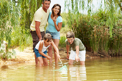 Buy stock photo Family, net and fishing in lake for break with countryside, vacation and relax in nature together. Parents, children and bonding with game outdoor for holiday, summer trip and travel in forest