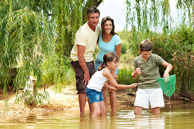 Buy stock photo Family, net and fishing in lake for bonding with countryside, vacation and relax in nature together. Parents, children and break with game outdoor for holiday, summer trip and travel in forest
