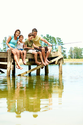 Buy stock photo Fishing, pier and family with children by lake for summer vacation, holiday and bonding in nature. Travel, space and dock with mom, dad and kids for adventure, weekend and learning to catch fish