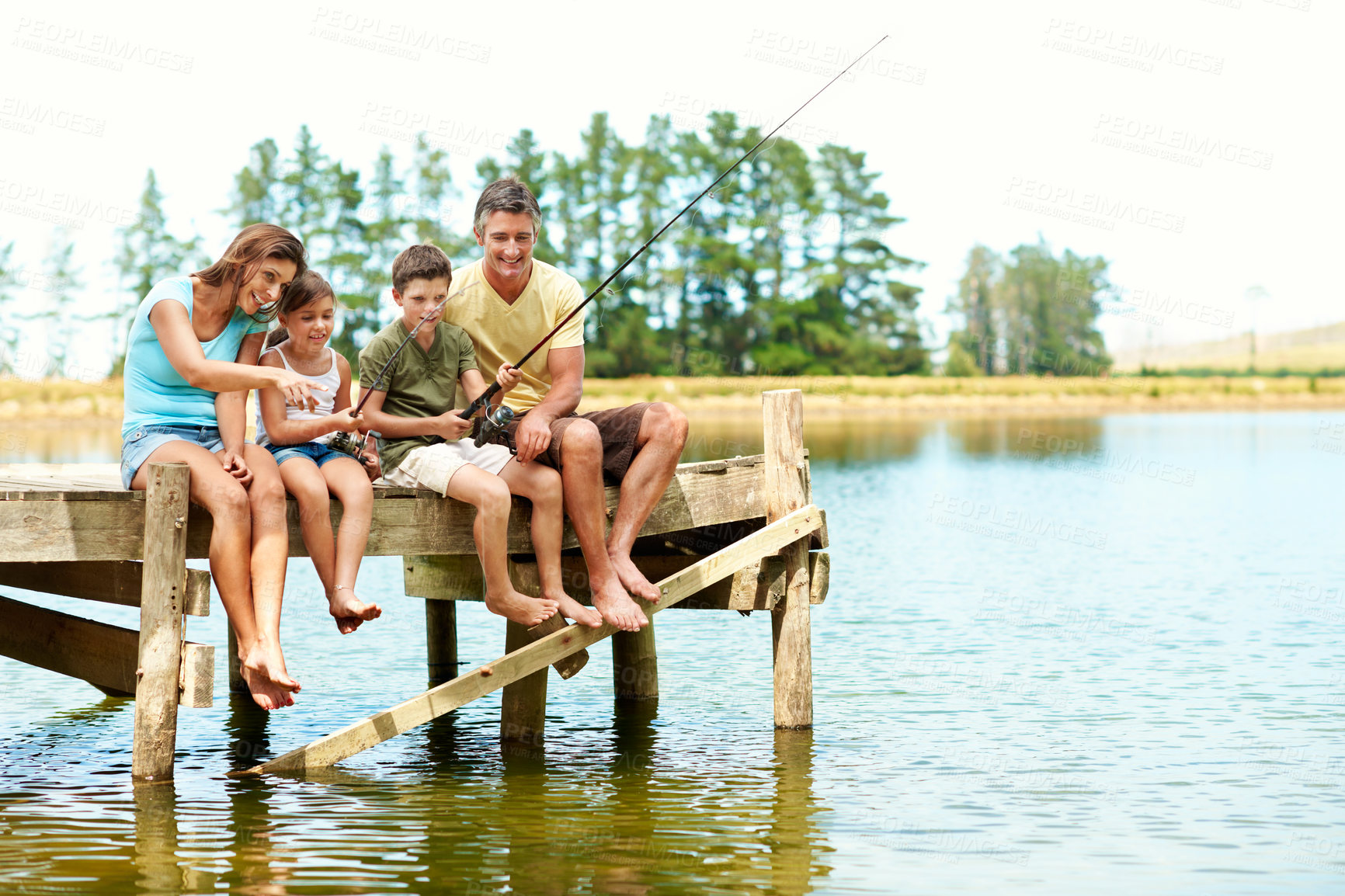 Buy stock photo Fishing, dock and parents with children by lake for summer vacation, holiday and bonding together. Family, nature and pier with mom, dad and kids for adventure, space and learning to catch fish