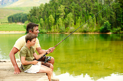 Buy stock photo Outdoor, dad and fishing with teenager, lake and bonding with son on holiday or connection in nature. Family, hobby and happy man with rod to catch fish in water, learning and tips for boy and fun