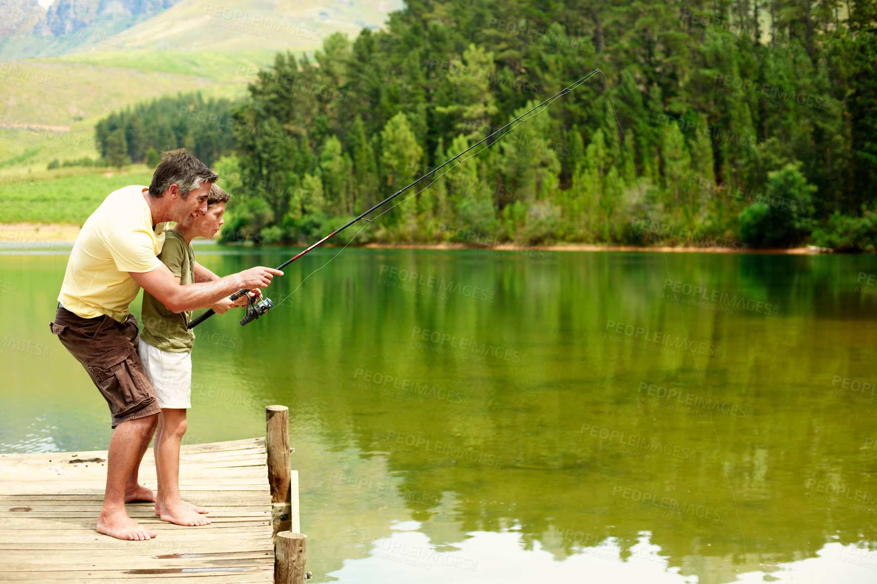Buy stock photo Happy, family and fishing with teenager, lake and dad with son on vacation and connection in nature. Outdoor, hobby and man with rod to catch fish in water, space and advice for boy and bonding