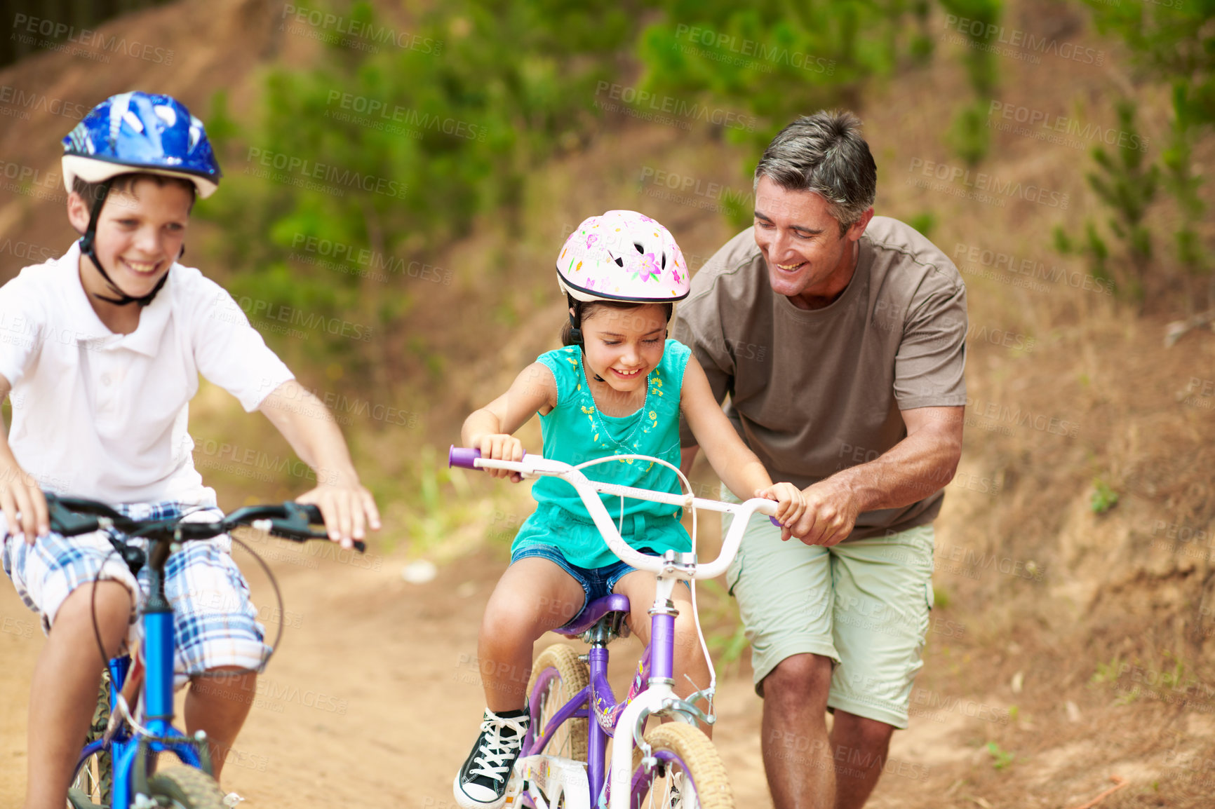 Buy stock photo Support, dad or children outdoor with bicycle, bonding together and guidance in summer hobby. Smile, cycling and family with helping, teaching moment and parent connection for childhood development.