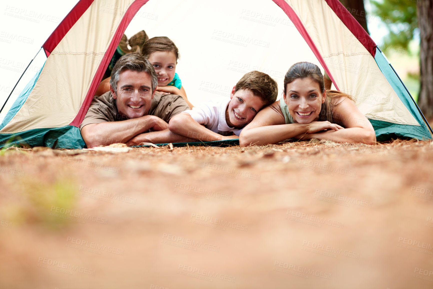 Buy stock photo Portrait, parents and children at campsite with tent, care and bonding together for summer vacation. Space, mother and father camping outdoor in woods with kids, happy family and weekend holiday.