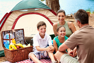 Buy stock photo Parents, children and camping by lake with tent, picnic basket or bonding together for summer holiday. Happy family, mother and father outdoor at campsite with kids, river or vacation for connection.