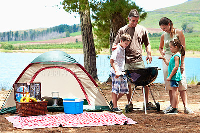 Buy stock photo Family, camping and barbecue by lake for holiday with love, bonding and relax in nature together. Mother, father and children with tent outdoor for vacation, summer trip and travel with grill
