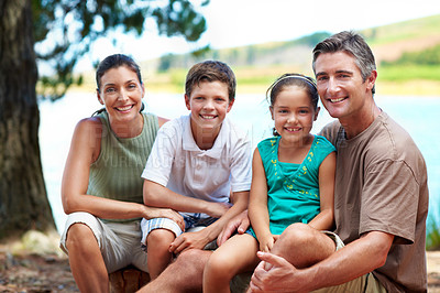 Buy stock photo Family, smile and portrait by lake for vacation with love, bonding and relax in nature together. Mother, father and children with people in forest for holiday, summer trip and travel in wilderness