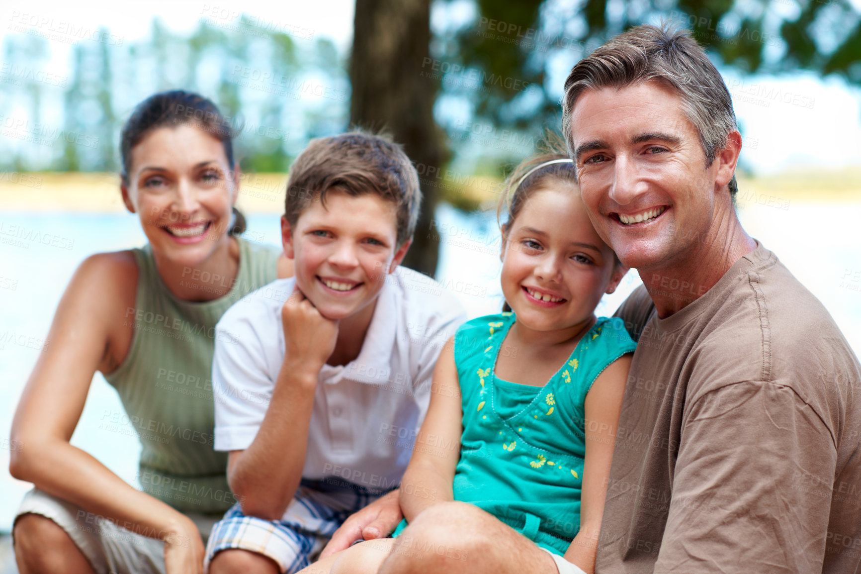 Buy stock photo Family, smile and portrait by lake for travel with love, bonding and relax in nature together. Mother, father and children with people in forest for holiday, summer trip and vacation in wilderness
