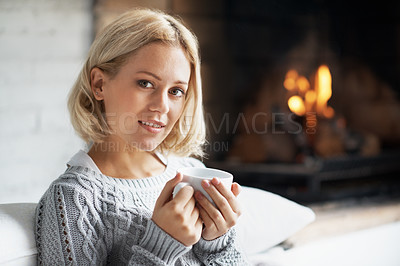 Buy stock photo Portrait of a beautiful young woman sitting on a couch with a mug of coffee