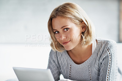 Buy stock photo Cropped shot of a beautiful young woman smiling and holding her digital tablet