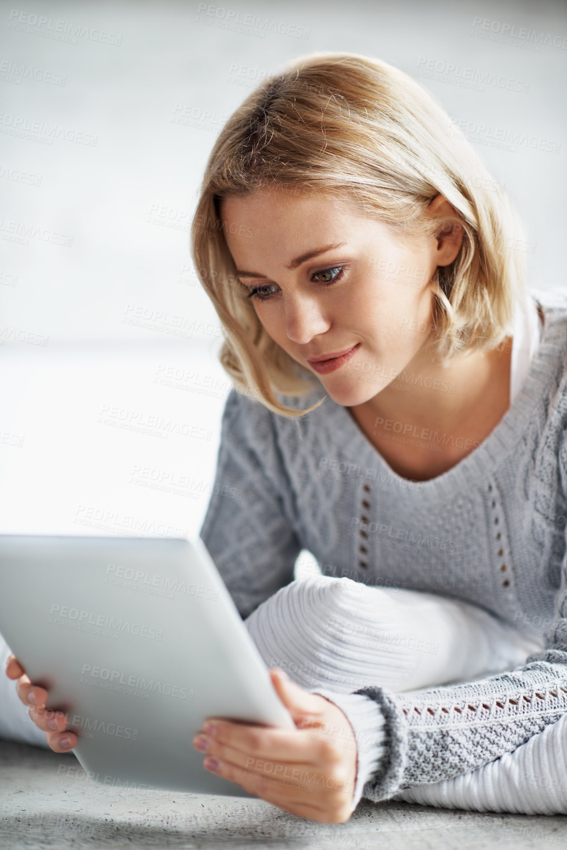Buy stock photo Reading, online and woman on tablet in home for internet, connection and networking on weekend. Smile, house and person on digital tech for research, subscription and ebook on website for break