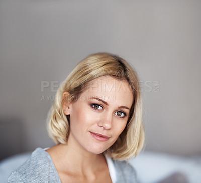 Buy stock photo A head and shoulders shot of a beautiful happy woman sitting in her home