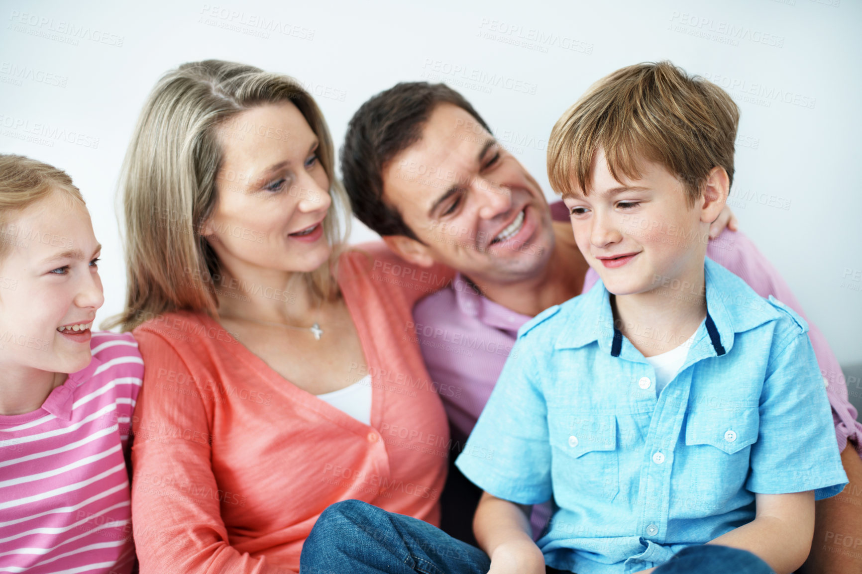 Buy stock photo Childcare, smile and family in home with hug, child growth or bonding together on weekend break. Relax, parents or kids with embrace, happy moment or sibling connection in childhood development.