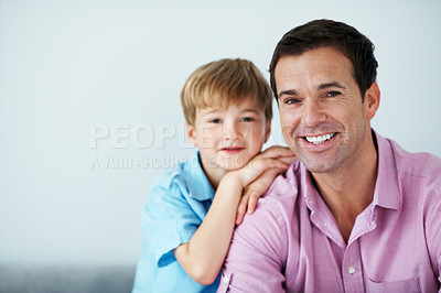 Buy stock photo Portrait, dad and child in living room with support, family bonding together and happy for parenthood. Space, man and son relax in house with weekend break, connection and smile for fathers day.