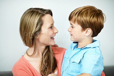 Buy stock photo Mother, relax and child in home with smile, love and affection for bonding together. Happy, woman and funny discussion in living room with son, family connection and comfortable for weekend break