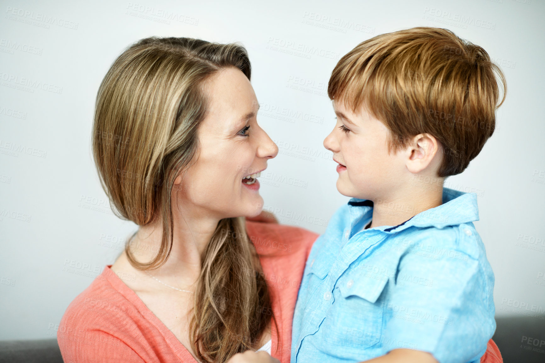 Buy stock photo Mother, relax and child in home with smile, love and affection for bonding together. Happy, woman and funny discussion in living room with son, family connection and comfortable for weekend break