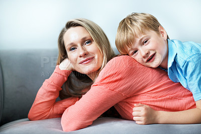 Buy stock photo Portrait, mother and relax on sofa with child, love and affection for bonding together. Happy, woman and embrace in living room with kid, family connection and comfortable for weekend break at house