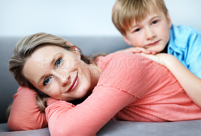 Buy stock photo Portrait, mother and smile on couch with child, love and affection for bonding together. Happy, woman and unwind in living room with kid, family connection and comfortable for weekend break at house