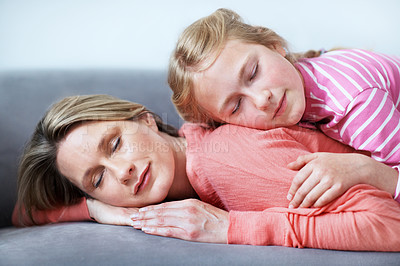 Buy stock photo Mother, daughter and sleeping in home with couch, comfortable and bonding together on weekend break. Woman, child and nap in living room with sofa, family connection and single parent relax with kid.