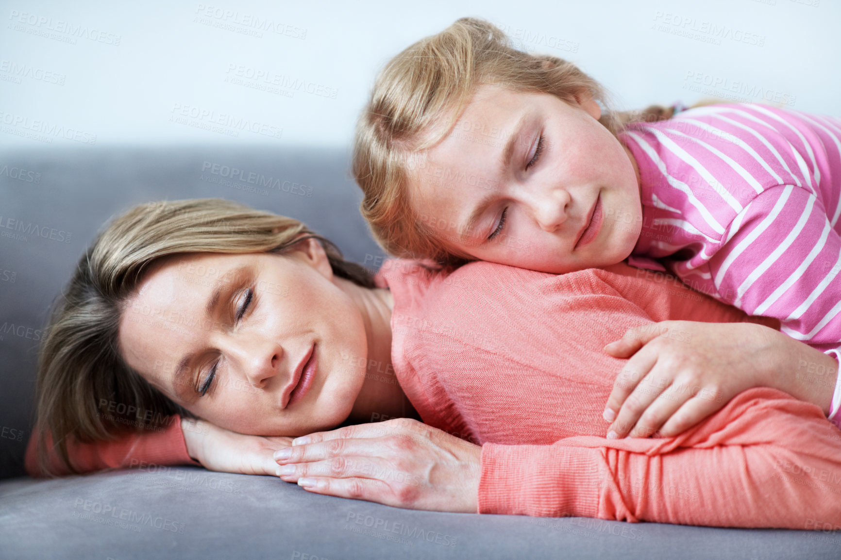 Buy stock photo Mother, daughter and sleeping in home with couch, comfortable and bonding together on weekend break. Woman, child and nap in living room with sofa, family connection and single parent relax with kid.