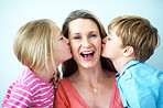 Family, kiss and mom with children in house, portrait and bonding with smile on break and connection. Happy woman, home and affection for kids, childcare and single parent with pride in Australia