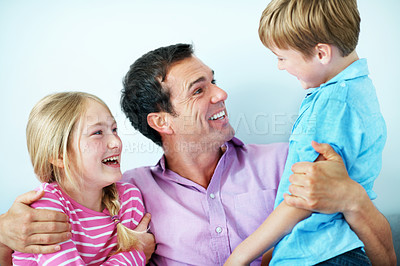 Buy stock photo Laughing, father and hug children for love, care and bonding together with joke in studio. Siblings, funny parent and embrace with dad for support, trust and family connection on white background