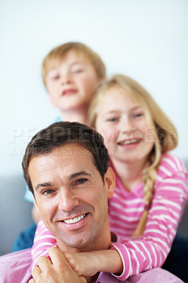 Buy stock photo Happy, dad and children in living room with hug, family bonding together and gratitude for papa. Portrait, man and kids embrace in house with support, connection and appreciation on fathers day.