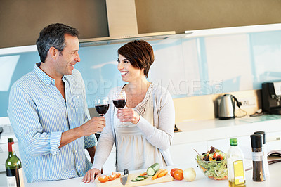 Buy stock photo Cooking, happy couple and cheers with wine in kitchen, laughing or bonding with partner in apartment. People, toast and celebration with alcohol, love and meal prep with ingredients for lunch in home