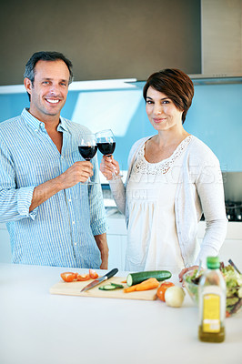Buy stock photo Cooking, happy couple and toast with wine, portrait and celebration with partner on weekend in home. People, bonding and cheers with alcohol, anniversary and meal prep with ingredients in kitchen