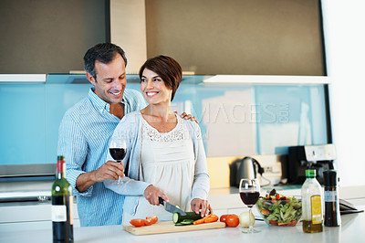 Buy stock photo Love, happy couple and cooking with red wine in kitchen, organic food and slice vegetables. Mature man, woman and meal prep at home with alcohol, healthy cucumber and vegetarian diet with connection