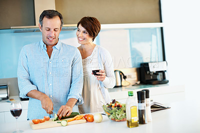 Buy stock photo Love, happy couple and cooking with red wine, chopping board and slice vegetables in home. Mature man, woman and meal prep at kitchen with alcohol, healthy cucumber and vegetarian diet for nutrition