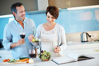 Buy stock photo Cooking, salad and happy couple with wine in kitchen, love and laugh with partner on weekend in home. Healthy food, meal prep and people with alcohol, connection and ingredients for lunch in house