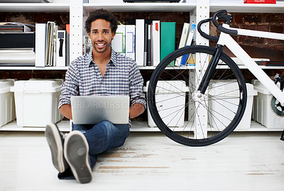 Buy stock photo Laptop, portrait and black man with bicycle in office for copywriting, online article and story draft. Creative, startup and person on computer for research, website blog and eco friendly transport
