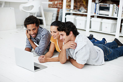 Buy stock photo Creative, meeting and people on floor with laptop, research and online video for digital marketing. Happy, team and workers on computer for website, streaming and relax on break at design agency