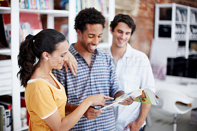 Buy stock photo Creative, people and project in office with magazine, review copywriting work and smile for teamwork. Happy, coworkers and copywriter check article for media publication, collaboration and planning.