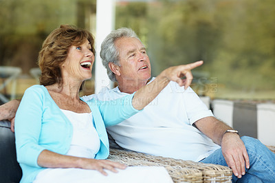 Buy stock photo Old couple, relax and pointing with smile on patio, love and calm morning with scenic view. Happy, senior people and vision at house for sightseeing, bonding together and weekend break on retirement
