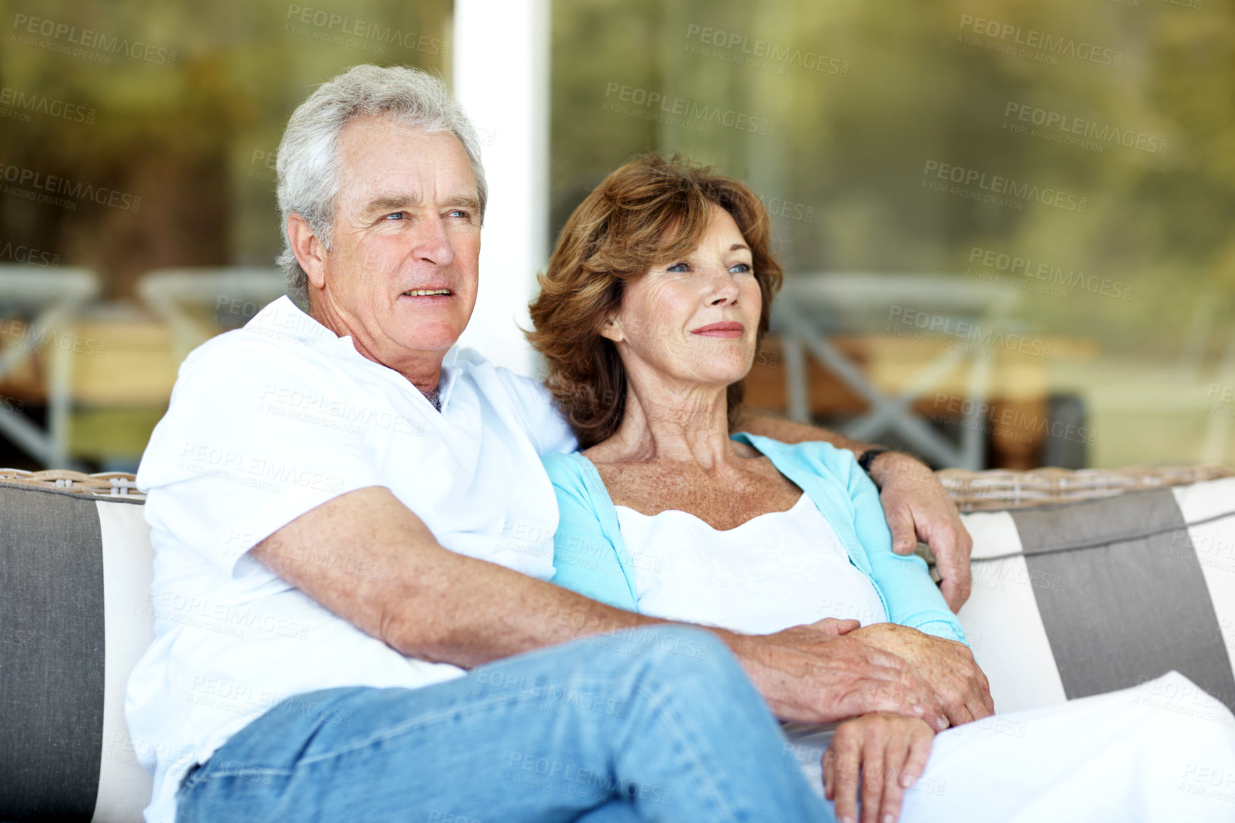 Buy stock photo Happy, thinking and senior couple on patio for bonding, marriage and connection on weekend. Retirement home, morning and man with woman on couch for relationship, love and relax together with embrace