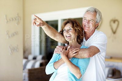 Buy stock photo Love, smile or old couple in backyard with pointing, happy connection or bonding on weekend break. Retirement, support or elderly people with hug, healthy relationship or romantic moment at home.