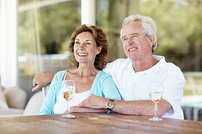 Buy stock photo Thinking, relax and old couple with wine on patio, peace and calm morning with scenic view. Smile, senior people and embrace in home with alcohol, partner affection and bonding together on retirement