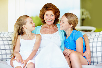 Buy stock photo Family, grandma and girl children in living room, bonding and love with care in portrait on couch. Smile, connection and old woman with grandkids, trust and relationship with relax on sofa at home