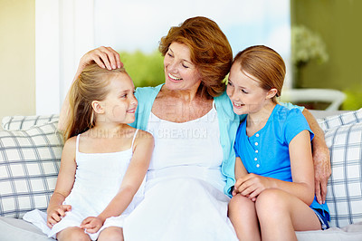 Buy stock photo Family, grandmother and girl children in living room, bonding and love with care on couch. Smile, connection and old woman with grandchildren, trust and relationship with relax on sofa at home