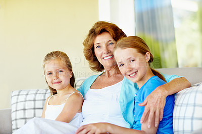 Buy stock photo Family, grandma and girl children on patio, bonding and love with care in portrait on couch. Smile, connection and old woman with grandkids, trust and relationship with relax on sofa on home porch