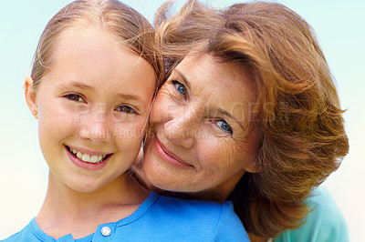 Buy stock photo Portrait, smile and grandmother with child outdoor, bonding and family love with care by blue sky. Happy, connection and old woman with girl or grandchild, trust and relationship with relax in nature