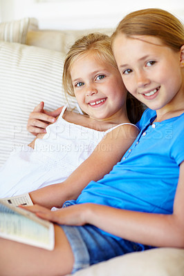 Buy stock photo Bonding, portrait or children on sofa with book, literature hobby or reading in healthy relationship. Happy, siblings or sisters in home with hug, family connection or learning together with magazine