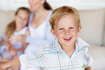 Buy stock photo Happy, relax and portrait of kid in home with childhood development, growth or bonding with family. Smile, calm and boy on sofa in living room with positive attitude, safety and trust in house.