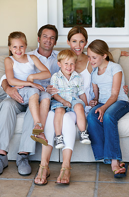 Buy stock photo Portrait, home and family with children on couch, love and parents with smile on break and together. Happy people, bonding and connection with kids on weekend, mother and father at house in Germany