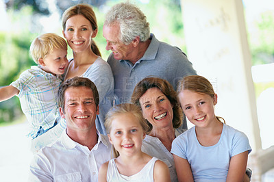 Buy stock photo Portrait, big family and happy together on patio, love and care with generations outdoor. Grandparents, parents and children with people bonding on home porch, smile or relax for trust and memory