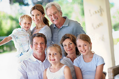 Buy stock photo Portrait, big family and smile together on patio, love and care with generations outdoor. Grandparents, parents and children with people bonding on home porch, happy or relax for trust and memory