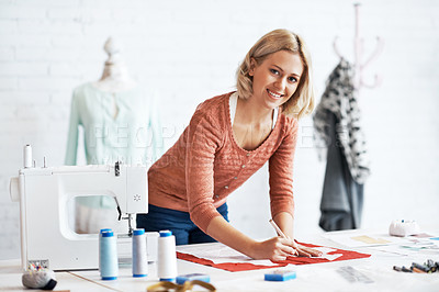 Buy stock photo Portrait of a beautiful young tailor drawing the outline of a pattern for a garment